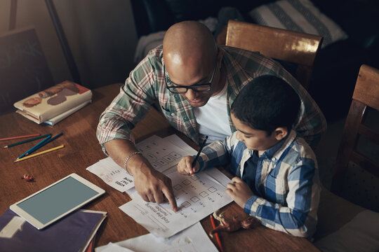 Father, child and help in house with homework discussion, math task and education for skill development. Above, man talk and son in home with assessment, numeracy and assistance for knowledge growth.