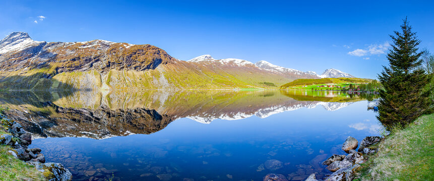 Landscape reflection in Eidsvatnet Lake, panoramic view.
