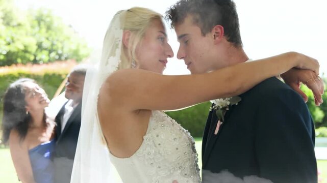 groom lifting bride with wedding veil, couple embracing for kiss, cloud wash rising over couple