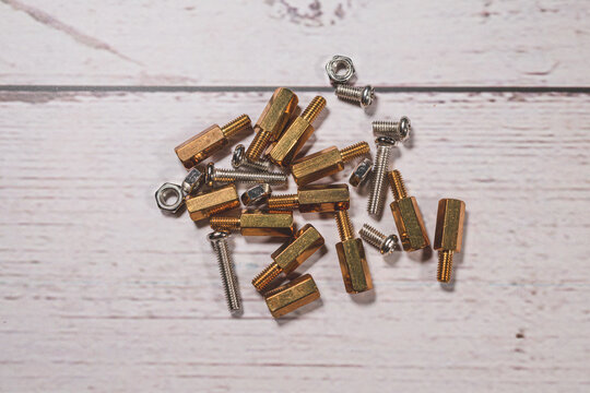 Brass standoffs screws and nuts for electronics assembly hardware mounting.