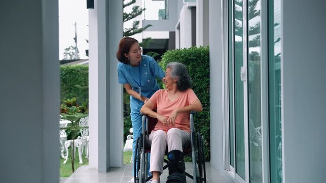Nurse helping senior woman move outside home, rehabilitation and supportive care concept
