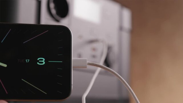 Close-up of plugging USB-C cable into smartphone from portable power station