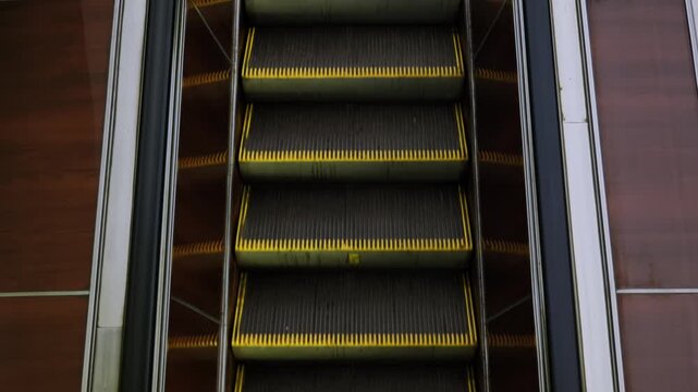 Empty going down escalator in Moscow metro, urban public transport infrastructure
