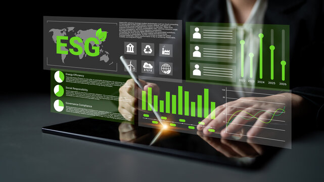 A business professional engaged in data analysis on a tablet, displaying ESG metrics and graphs, highlighting trends in environmental sustainability and corporate responsibility. Gantry
