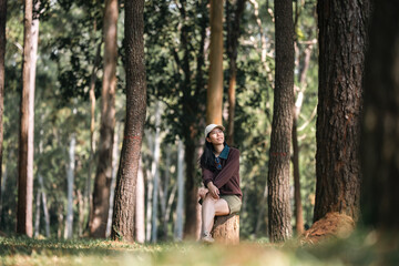 Fototapeta premium Asian woman relaxing in forest nature wellness lifestyle mindfulness meditation peaceful outdoor environment mental health balance natural therapy freedom calm wellbeing