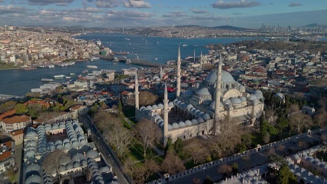 Aerial drone view of the historic Golden Horn in Istanbul, showing the Suleymaniye Mosque, Galata Bridge and the Bosphorus. Galata Tower and Taksim Square in the distance.