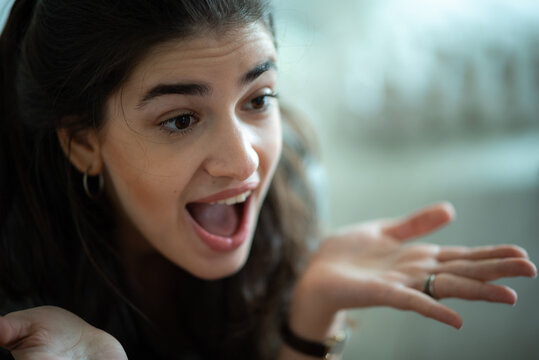 Surprised woman open mouth shocked expression confused gesture raised eyebrows casual home emotional reaction talking female adult close up portrait Surprised woman with open mouth and shocked