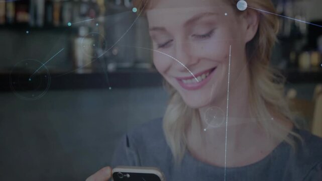 Vertical video: Tapping woman holding phone with grip in gray top, smiling reading text at bar