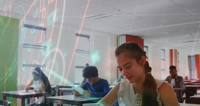 Teen female picking up tablet and studying while projector holograms syncing to tablet in classroom