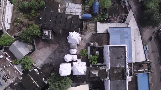 Wide aerial drone shot of Chhatia Bata Jagannath Temple surrounded by greenery in Odisha, India.