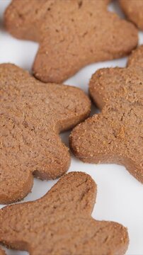 Assorted crunchy gingerbread shapes arranged for holiday presentation. Varied silhouettes of gingerbread cookies with vibrant studio illumination suitable for packaging