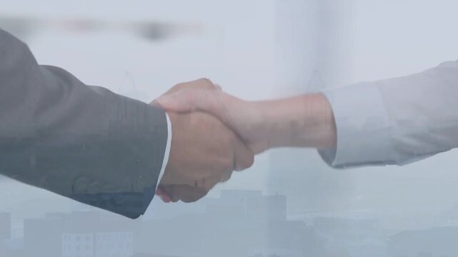 Two professionals' forearms entering, shaking hands in business scene, skyline overlay sealing deal