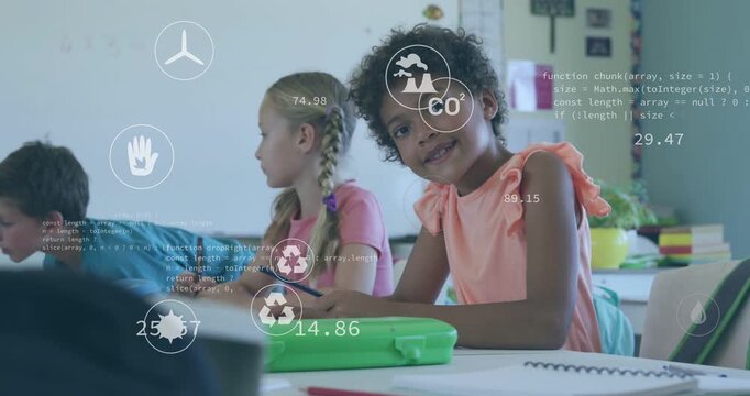 Students writing in classroom, central girl pausing and looking up for feedback, CO2 charts rising