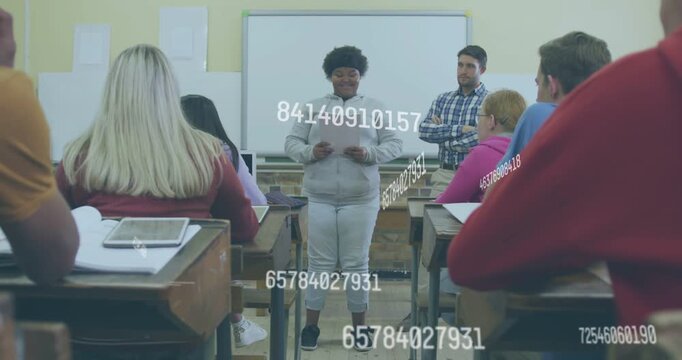 Vertical video: Reading student in gray hoodie presenting paper to classmates with numeric overlays