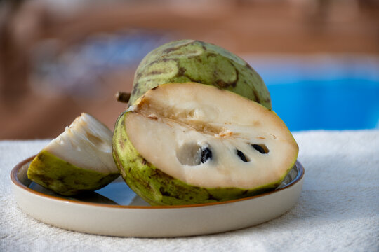 Tasty exotic fruit cherimoya with creamy structure close up isolated on white
