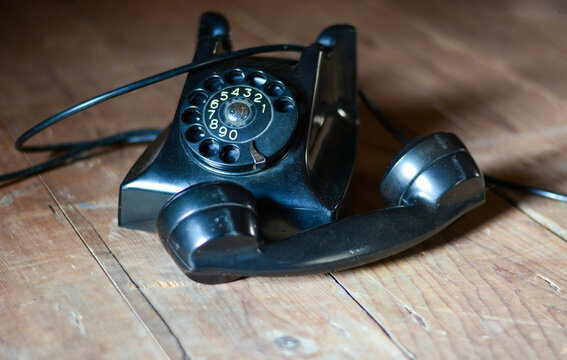 an old telephone from the 60s on an old wooden table