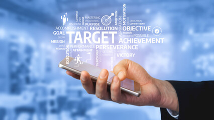 Obraz premium A close-up of a hand holding a smartphone displaying a collage of motivational words related to success, inspiration, and achievement in a business context. Tessel
