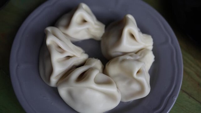 Traditional dumplings khinkali served on plate soft dough folds Georgian cuisine close up food texture simple homemade meal authentic dish minimal style