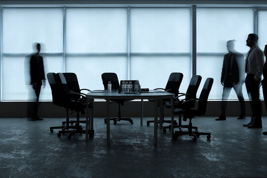 Silhouettes of moving business people in office