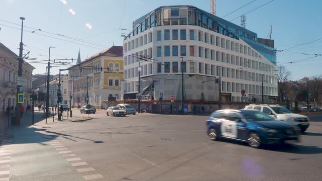 Morning traffic at Ferdinand and Baritiu intersection in Cluj-Napoca, BT Building