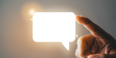 Obraz premium Glowing speech bubble held by hand for business communication and digital message