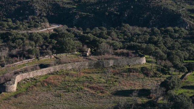Scenic aerial view of the ancient Vetton fortress Yecla la Vieja, showcasing its historic stone walls and surrounding lush green landscape in Yecla de Yeltes, Spain