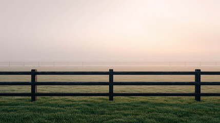 Fototapeta premium A scenic view of a black fence in a foggy meadow