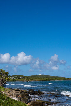 Lighthouse in the distance on a hill in front of the water in Fajardo Puerto Rico 