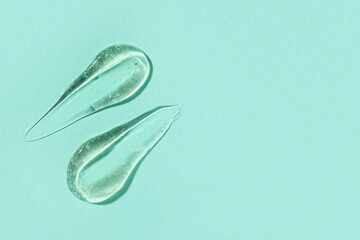 Samples of cosmetic gel on turquoise background, closeup © Pixel-Shot