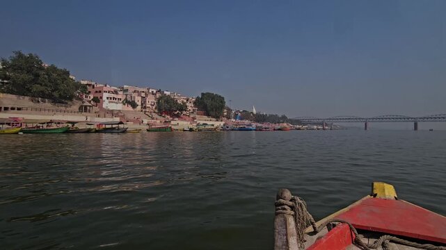 View from a moving boat on the Ganges River at Varanasi Ghats. Sacred river, historic Ghats, and spiritual atmosphere, showcasing Indian culture, rituals, and timeless heritage. Uttar Pradesh, India