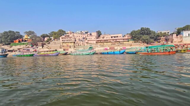 View from a moving boat on the Ganges River at Varanasi Ghats. Sacred river, historic Ghats, and spiritual atmosphere, showcasing Indian culture, rituals, and timeless heritage. Uttar Pradesh, India