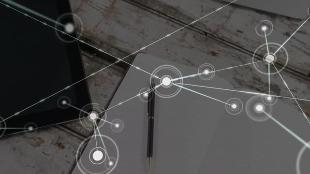 Flat design network overlay spreading across rustic desk, connecting tablet, laptop, notepad