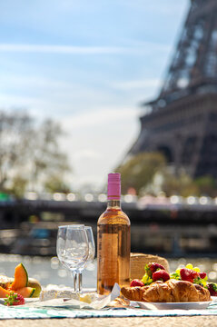 Picnic and wine near the Eiffel Tower. Selective focus.