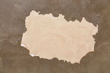 Fototapeta premium Burnt paper sheet on grunge background
