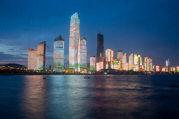 Naklejka premium Seaside city glittering night skyline in Qingdao, China