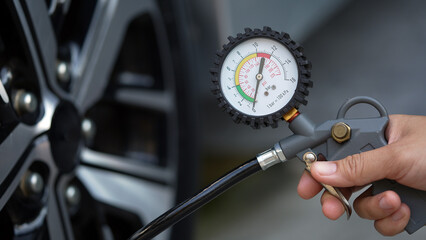 Inflate your car tires to save fuel before traveling © Rattanakun