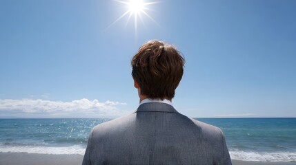 Fototapeta premium Businessman in suit on beach looking at ocean and sun symbolizing future opportunities and success