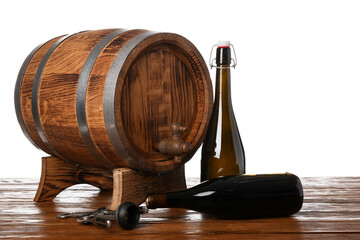 Naklejka premium Wooden barrel and bottles of wine on table against white background