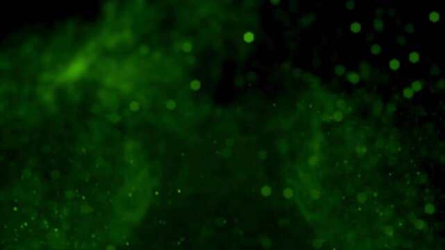 Green background with bokeh effect and small dots of light, abstract dark green texture with glowing specks