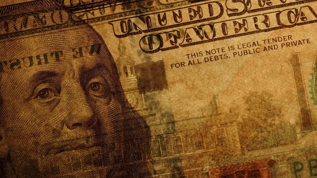 Portrait Of Franklin On A Hundred Dollars Slowly And Partially Illuminated With Light Examining Watermarks And Security Features.