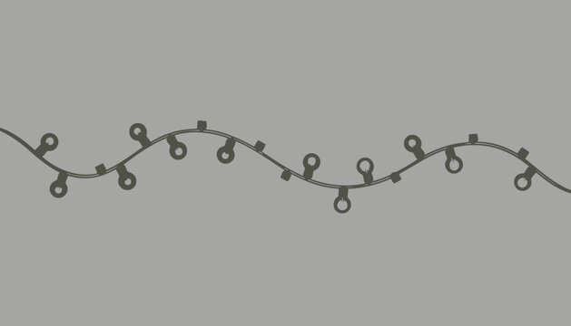 A string of Christmas lights on a gray background.