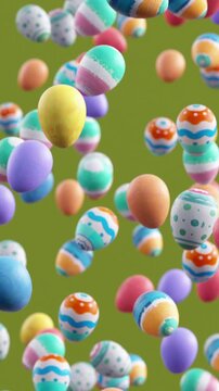 Looping video of decorated Easter eggs falling in slow motion on green background, festive spring holiday concept with colorful patterns and playful seasonal 3D animation