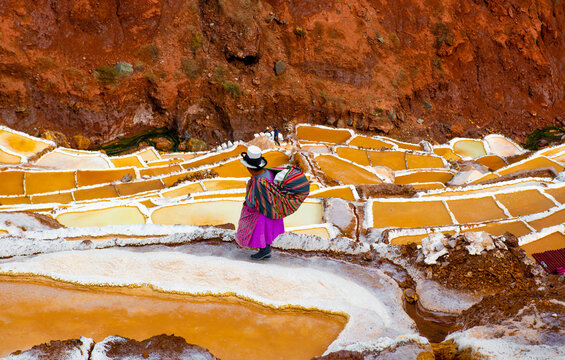 Woman Walking On Maras Salt Terraces
