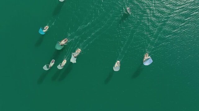 A view of yachts sailing on the open sea on a windy day.