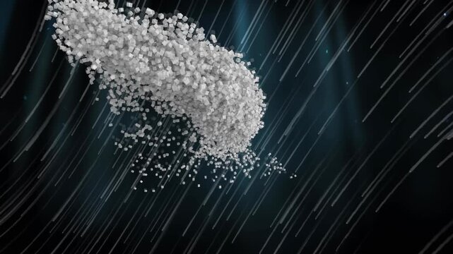 Animation of small particles forming a human head model against light trails over black background