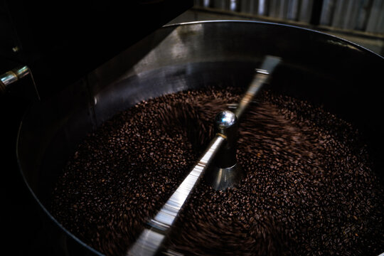 Industrial Coffee Bean Roasting Machine Agitating Fresh Roasted Beans During The Cooling Process In A Modern Facility