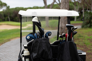 Fototapeta premium Golf Cart on Fairway at green golf course, parked, outdoor golf vehicle, relaxing sport environment.