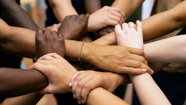 Large Diverse Group of Multiracial People Stacking Hands Together Showing Unity, Solidarity and Inclusion Close-Up Teamwork Photography