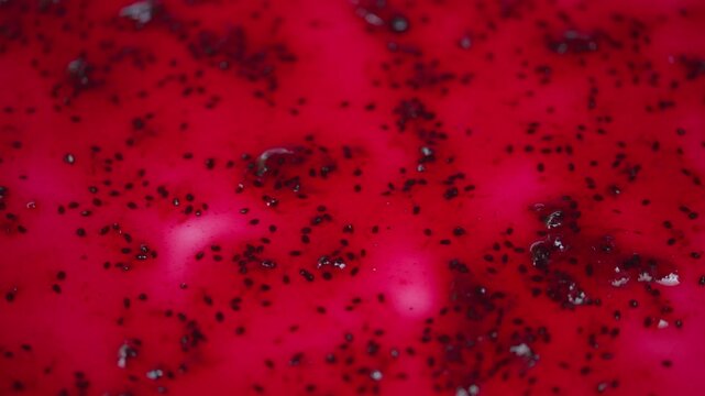 Closeup image showcasing reflective currant jelly with scattered seeds. Highresolution macro photograph emphasizing sparkly surface and seed distribution in delicious currant jam