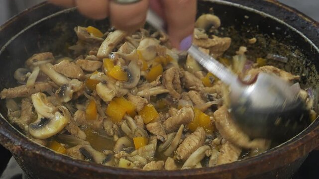 Chicken in teriyaki sauce and champignons are fried in vegetable